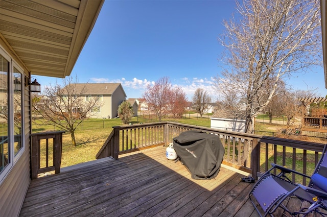 4328 125th St, Urbandale, IA 50323 - deck featuring area for grilling, a lawn, an outdoor structure, and a residential view