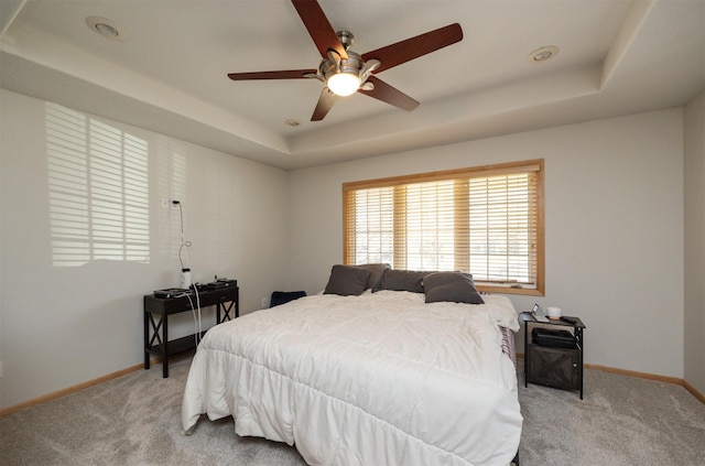 4328 125th St, Urbandale, IA 50323 - bedroom featuring a tray ceiling, light carpet, and baseboards