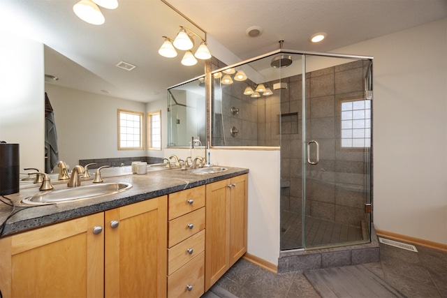 4328 125th St, Urbandale, IA 50323 - full bathroom with a shower stall, tile patterned flooring, double vanity, and baseboards