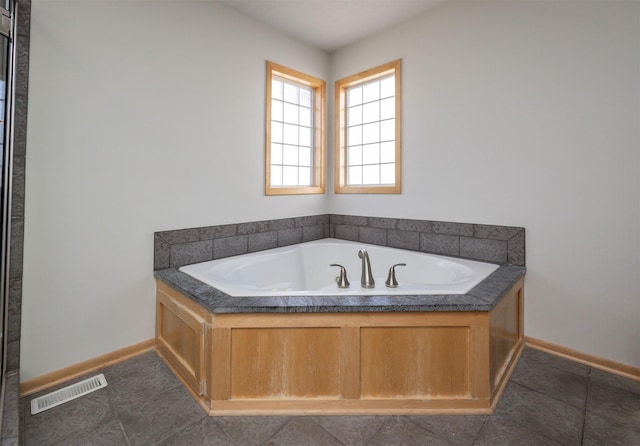 4328 125th St, Urbandale, IA 50323 - bathroom with a bath, baseboards, and tile patterned floors