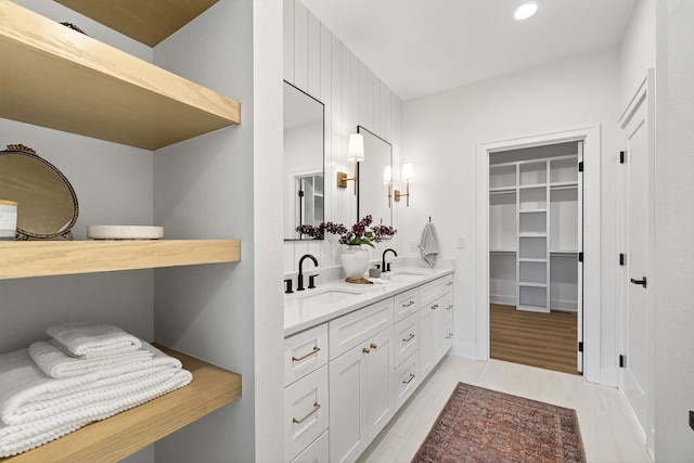1284 NW 29th Ct, Grimes, IA 50111 - bathroom with double vanity, a spacious closet, and recessed lighting