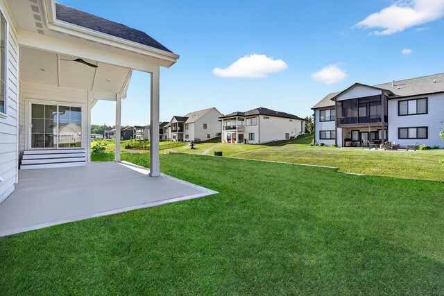 1284 NW 29th Ct, Grimes, IA 50111 - view of green lawn with a residential view, a patio area, and a sunroom