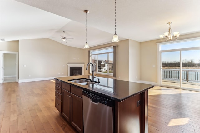 7821 NW 96th St, Johnston, IA 50131 - kitchen with dishwasher, a sink, open floor plan, a fireplace, and a chandelier