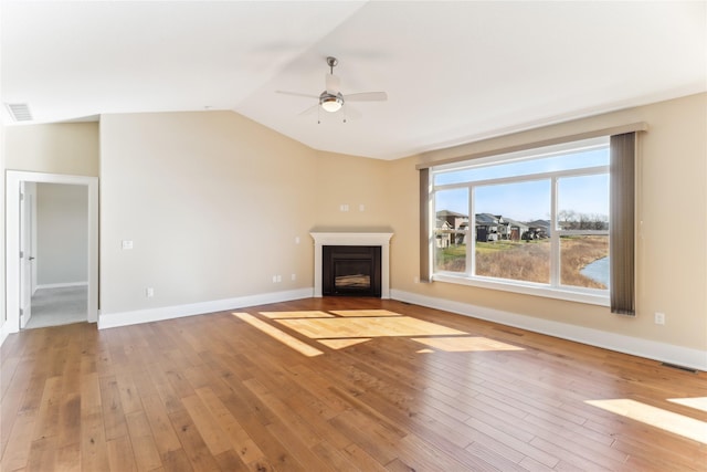 7821 NW 96th St, Johnston, IA 50131 - unfurnished living room with ceiling fan, light wood-style floors, a fireplace, lofted ceiling, and baseboards