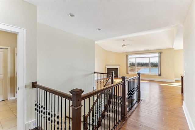 7821 NW 96th St, Johnston, IA 50131 - corridor with an upstairs landing, baseboards, and wood finished floors