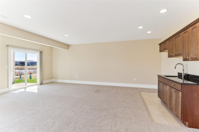 7821 NW 96th St, Johnston, IA 50131 - kitchen with a sink, recessed lighting, light carpet, and baseboards
