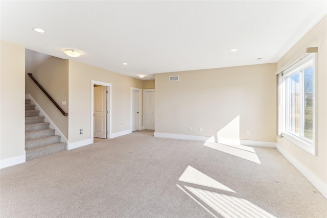 7821 NW 96th St, Johnston, IA 50131 - spare room with light colored carpet, stairs, baseboards, and recessed lighting