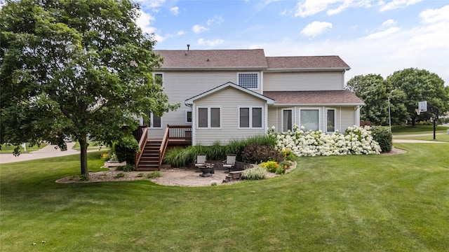 4850 Augusta Ln, Pleasant Hill, IA 50327 - back of property featuring an outdoor fire pit, stairway, a wooden deck, and a lawn