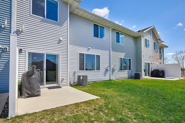 back of house with a yard, central AC unit, and a patio area
