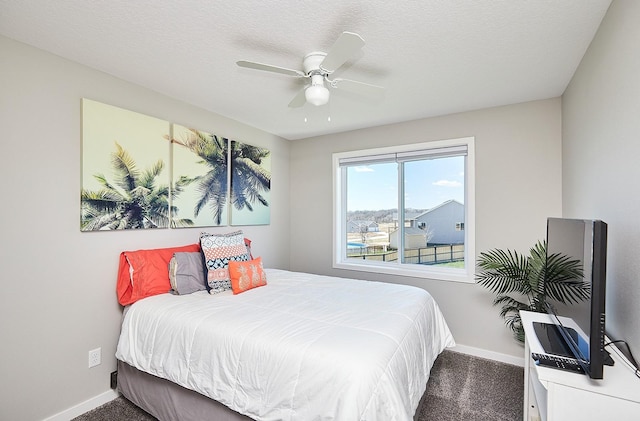 bedroom featuring baseboards, a ceiling fan, and carpet flooring