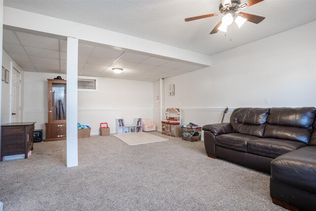 200 Space Ave SW, Mitchellville, IA 50169 - carpeted living room featuring a ceiling fan and a drop ceiling