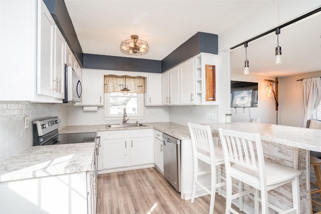 200 Space Ave SW, Mitchellville, IA 50169 - kitchen with a sink, appliances with stainless steel finishes, backsplash, and white cabinets