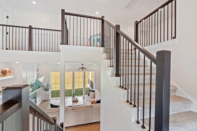 25019 Eagle Vista Dr, Adel, IA 50003 - stairs featuring wood finished floors and a high ceiling