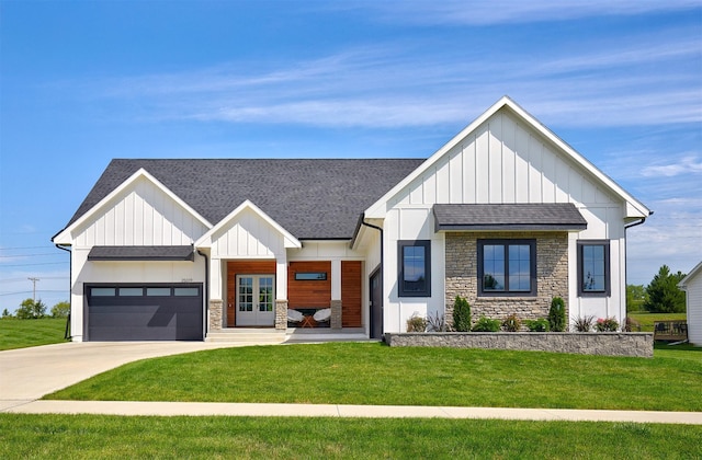 25019 Eagle Vista Dr, Adel, IA 50003 - modern farmhouse featuring board and batten siding, stone siding, roof with shingles, a front lawn, and an attached garage
