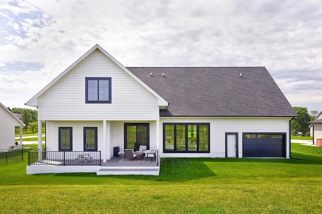 25019 Eagle Vista Dr, Adel, IA 50003 - rear view of house with a garage, a yard, a shingled roof, and a patio area