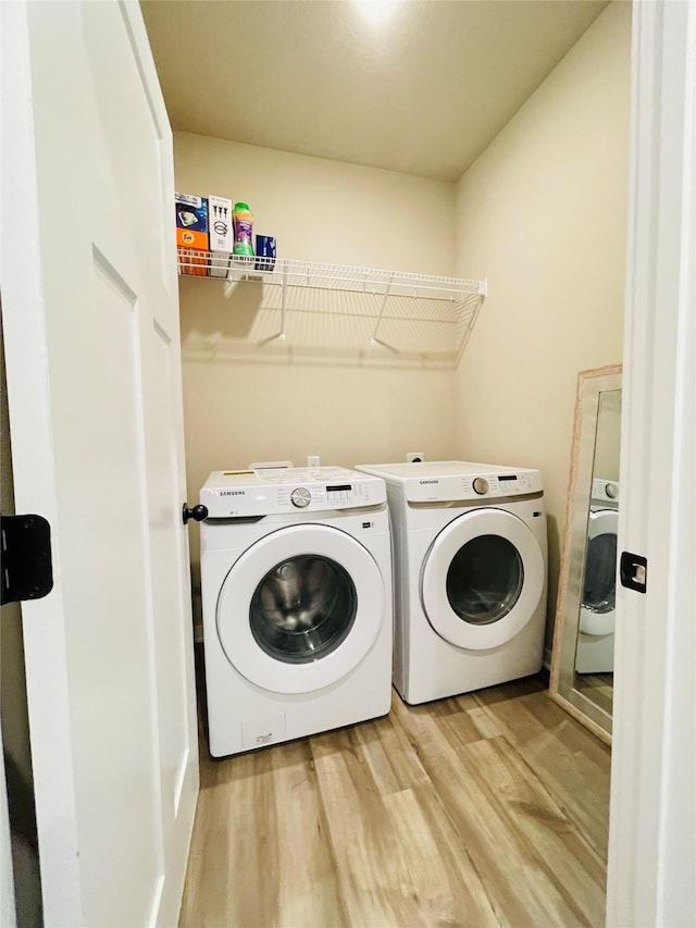 425 SE Hollow Ct, West Des Moines, IA 50265 - laundry room with laundry area, light wood-style flooring, and washer and dryer