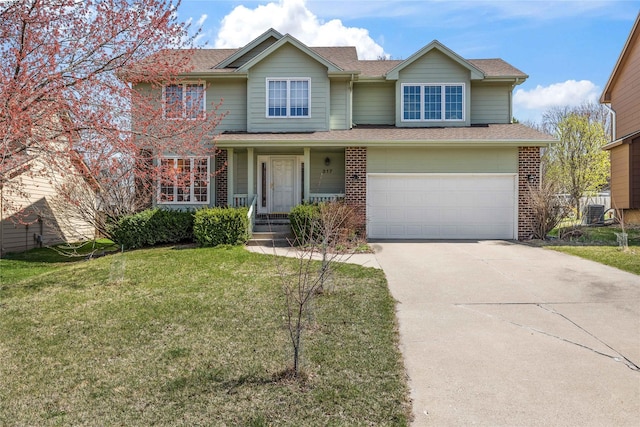 317 59th St, West Des Moines, IA 50266 - view of front facade with an attached garage, brick siding, driveway, a front lawn, and a shingled roof