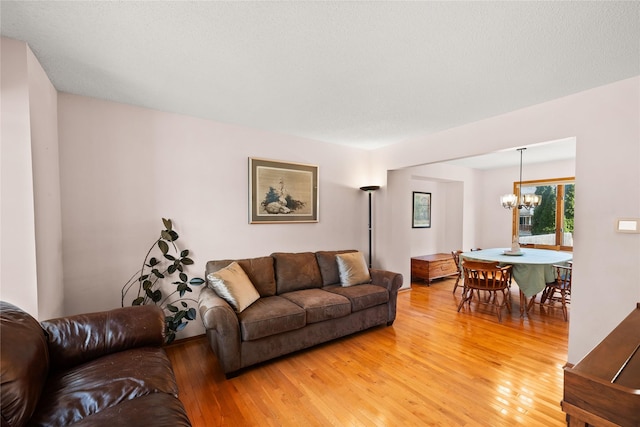 317 59th St, West Des Moines, IA 50266 - living area with a chandelier and light wood-style flooring