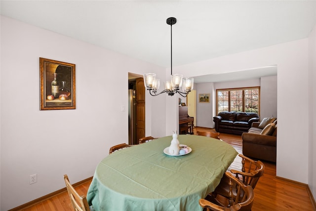 317 59th St, West Des Moines, IA 50266 - dining room featuring a chandelier, wood finished floors, and baseboards