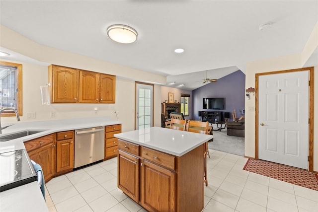317 59th St, West Des Moines, IA 50266 - kitchen with stainless steel dishwasher, a sink, ceiling fan, brown cabinets, and vaulted ceiling