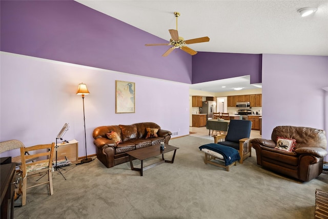 317 59th St, West Des Moines, IA 50266 - living room with a ceiling fan, light colored carpet, high vaulted ceiling, and baseboards