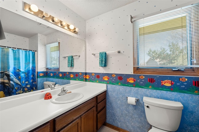 317 59th St, West Des Moines, IA 50266 - bathroom featuring toilet, wallpapered walls, vanity, wainscoting, and curtained shower