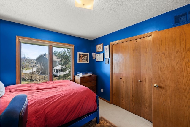 317 59th St, West Des Moines, IA 50266 - carpeted bedroom with a closet and a textured ceiling