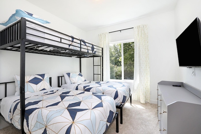 bedroom with baseboards and light colored carpet