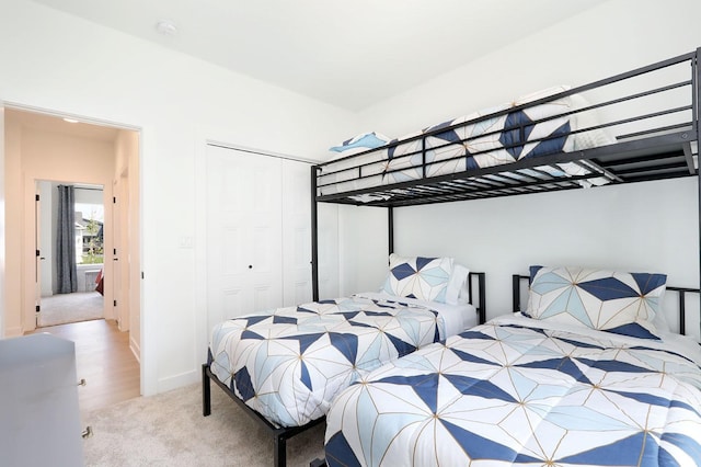 carpeted bedroom with a closet