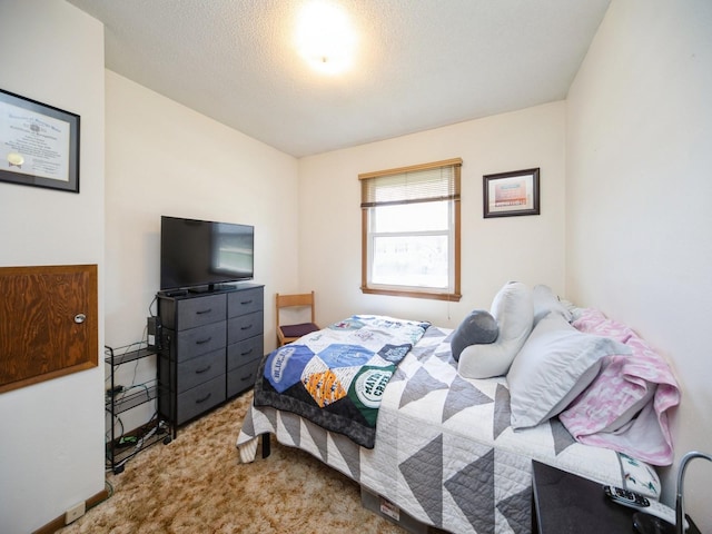 carpeted bedroom featuring a textured ceiling
