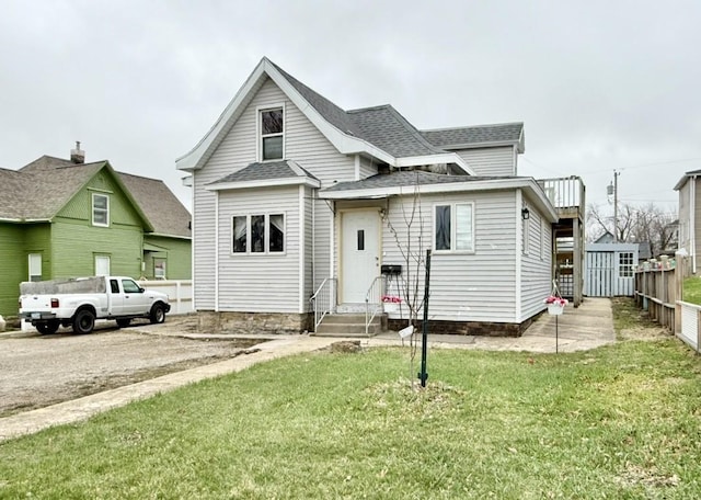 603 E Church St, Marshalltown, IA 50158 - view of front of property with a front yard, a shingled roof, fence, and entry steps