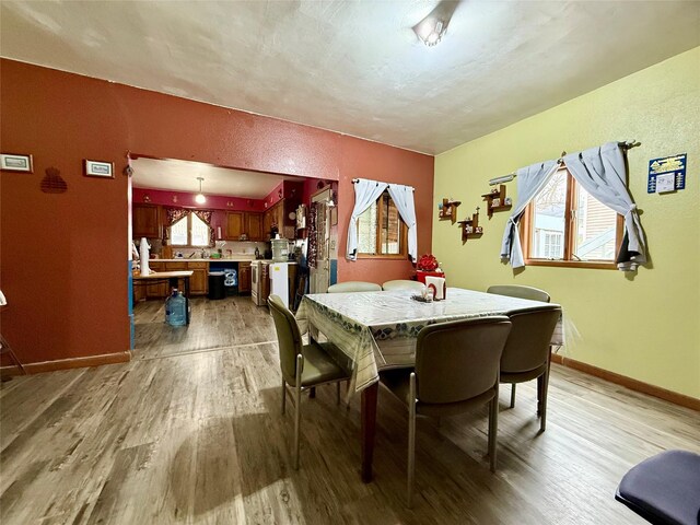 603 E Church St, Marshalltown, IA 50158 - dining area featuring baseboards, a textured wall, and light wood finished floors