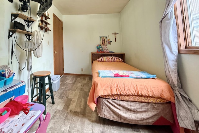 603 E Church St, Marshalltown, IA 50158 - bedroom featuring baseboards and wood finished floors