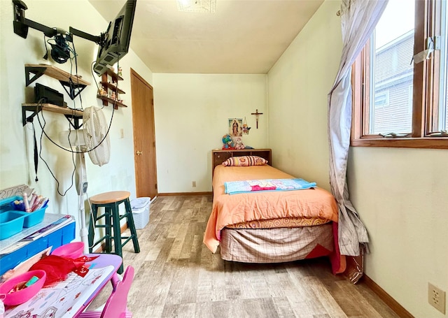 603 E Church St, Marshalltown, IA 50158 - bedroom featuring baseboards and wood finished floors