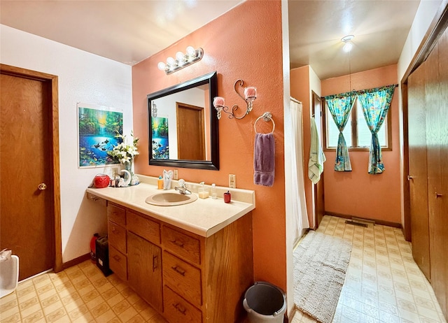 603 E Church St, Marshalltown, IA 50158 - bathroom with tile patterned floors, visible vents, baseboards, and vanity