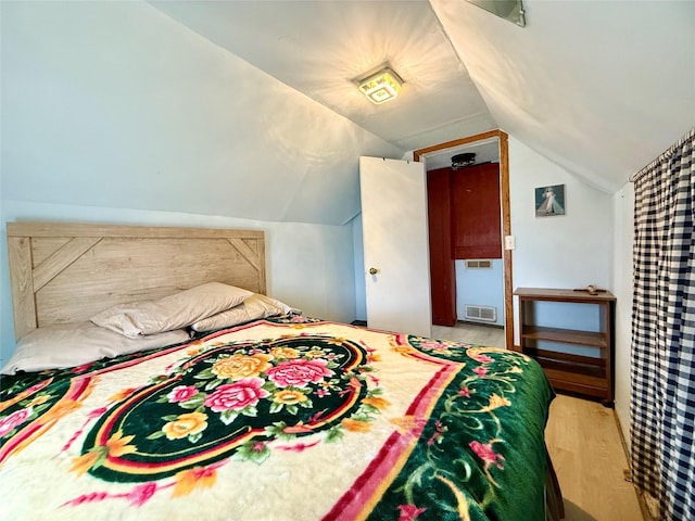 603 E Church St, Marshalltown, IA 50158 - bedroom featuring lofted ceiling, visible vents, and wood finished floors