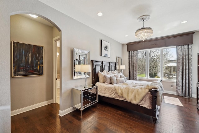 3144 Prairie Rose Dr, Norwalk, IA 50211 - bedroom with arched walkways, baseboards, dark wood-style floors, a chandelier, and recessed lighting