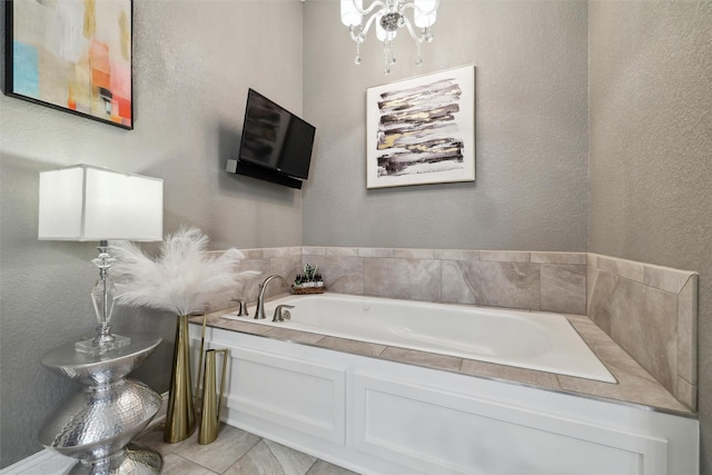3144 Prairie Rose Dr, Norwalk, IA 50211 - bathroom featuring tile patterned flooring, a garden tub, a textured wall, and a notable chandelier