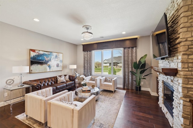 3144 Prairie Rose Dr, Norwalk, IA 50211 - living area with baseboards, wood-type flooring, and a stone fireplace