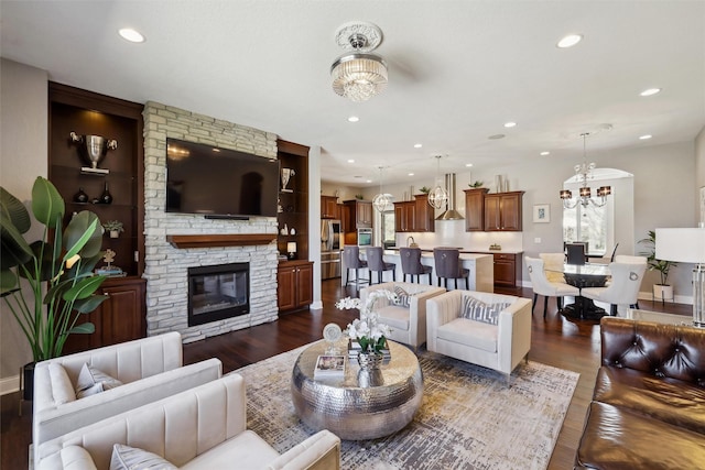 3144 Prairie Rose Dr, Norwalk, IA 50211 - living area featuring recessed lighting, a chandelier, dark wood-style floors, and a fireplace