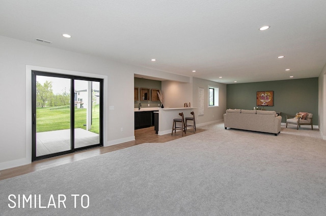 18048 Tanglewood Dr, Clive, IA 50325 - living room with recessed lighting, light colored carpet, and light wood-style flooring