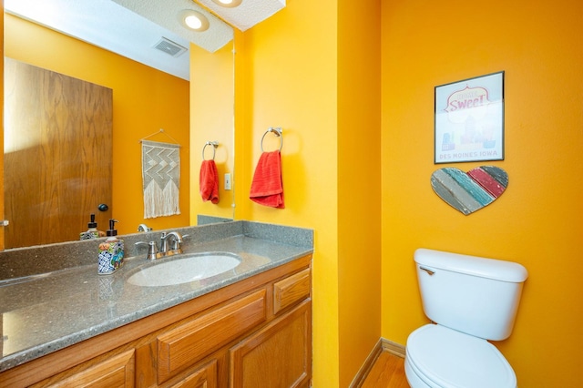 4774 Coachlight Dr, West Des Moines, IA 50265 - bathroom with toilet, vanity, and wood finished floors