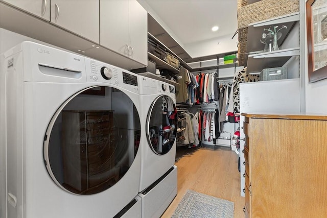 1645 SW Magazine Rd Unit 102, Ankeny, IA 50023 - laundry room with cabinet space, washing machine and dryer, and light wood-style flooring