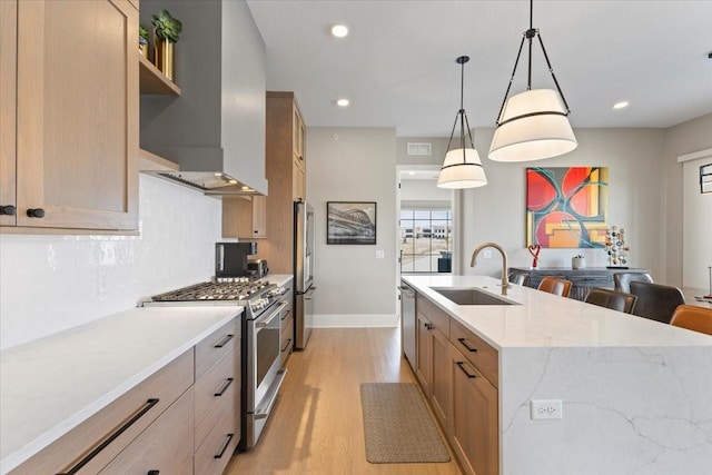 1645 SW Magazine Rd Unit 102, Ankeny, IA 50023 - kitchen with stainless steel appliances, wall chimney exhaust hood, light wood-style floors, backsplash, and recessed lighting