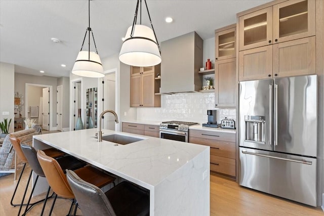 1645 SW Magazine Rd Unit 102, Ankeny, IA 50023 - kitchen featuring stainless steel appliances, premium range hood, light wood-type flooring, a center island with sink, and decorative backsplash