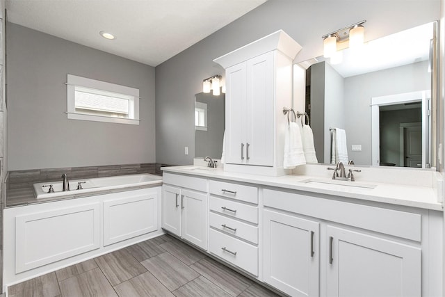 16206 Brookview Dr, Urbandale, IA 50323 - bathroom with double vanity, a garden tub, and recessed lighting