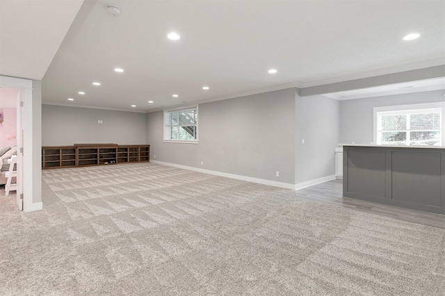 16206 Brookview Dr, Urbandale, IA 50323 - basement featuring crown molding, recessed lighting, baseboards, light carpet, and bar