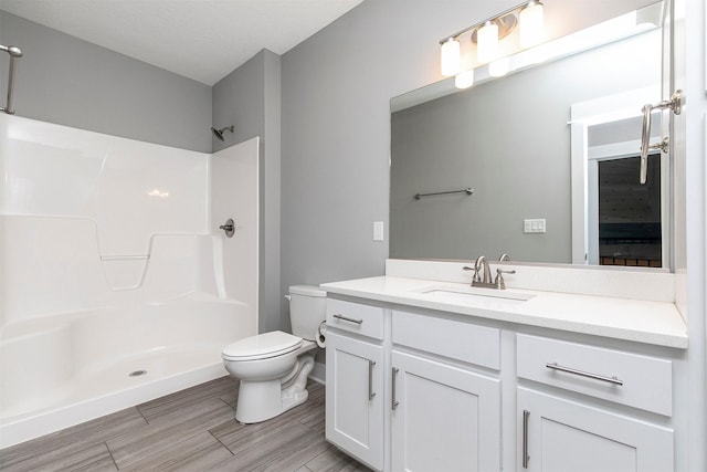 16206 Brookview Dr, Urbandale, IA 50323 - full bathroom featuring a shower, toilet, vanity, and wood finished floors