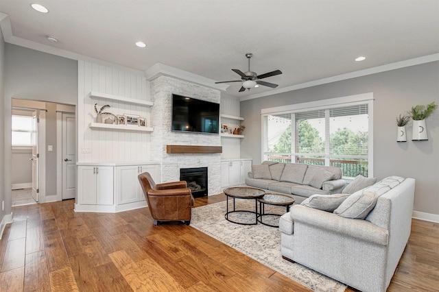 16206 Brookview Dr, Urbandale, IA 50323 - living area featuring crown molding, wood finished floors, a ceiling fan, a stone fireplace, and recessed lighting