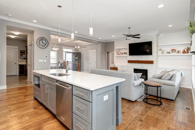 16206 Brookview Dr, Urbandale, IA 50323 - kitchen featuring gray cabinetry, dishwasher, a sink, a ceiling fan, and light countertops